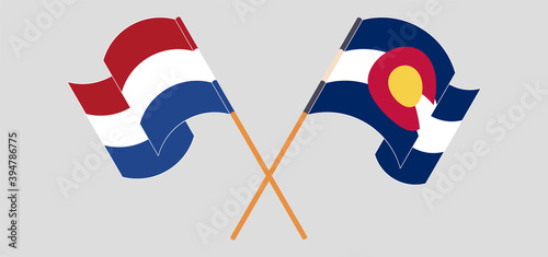 Crossed and waving flags of the Netherlands and The State of Colorado