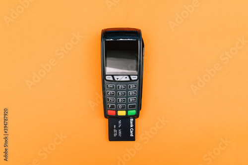The bank card is inserted into the POS payment terminal. Electronic device for receiving payments. The process of paying for goods, conducting a transaction