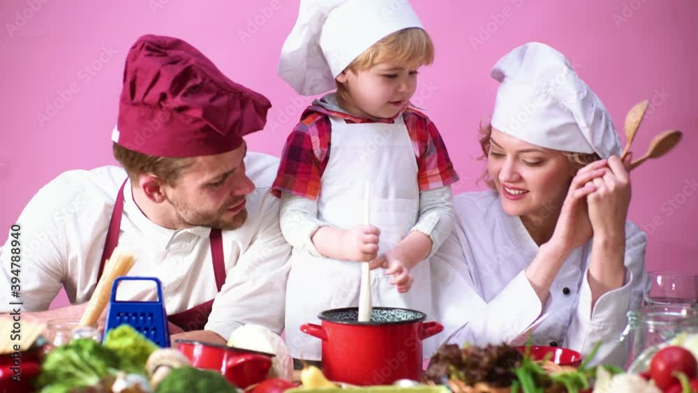 Young family cooking in chef hat. Father Mother and child son cooking together, happy family. Child Chef. Young family cooking in chef hat. Father Mother and child son cooking together, happy family. Child Chef.