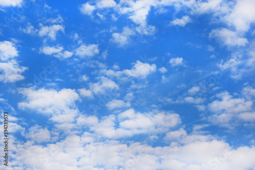 Bright blue sky background with tiny clouds. Sunny day.