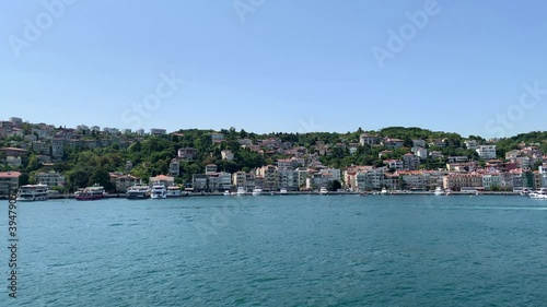 Footage of moored yachts and cruise tour boats at Kurucesme / Arnavutkoy area of Istanbul by Bosphorus strait. Beautiful scene. It is a sunny summer day. Camera moves forward. photo