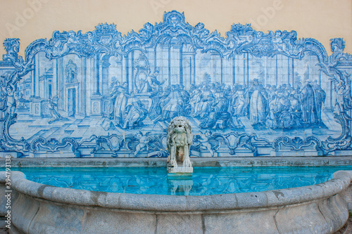 Beautiful fountain with blue tiles and an ornamental stone lion in Marechal Carmona park, Cascais, near Lisbon, Portugal