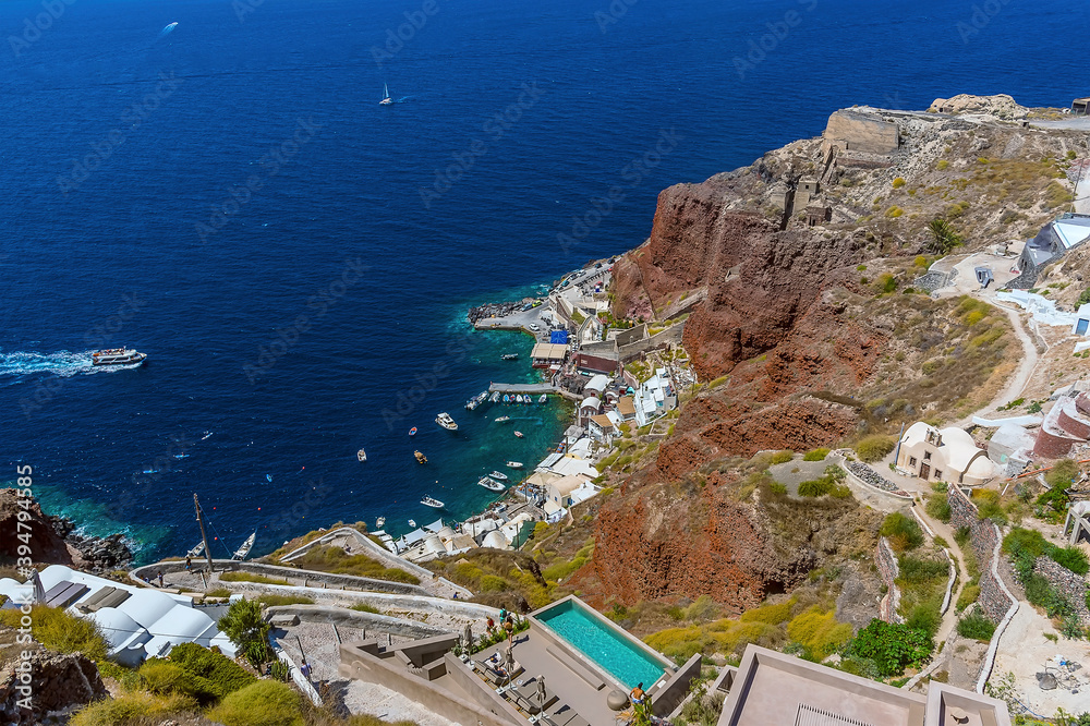 A view from the village of Oia, Santorini looking down towards Amoudi Bay in summertime