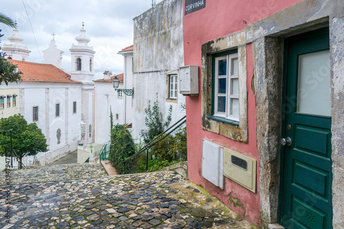 Cloudy day on the stairs and cobblestone floor near the church of Sao Miguel, in the Alfama district of Lisbon, capital of Portugal
