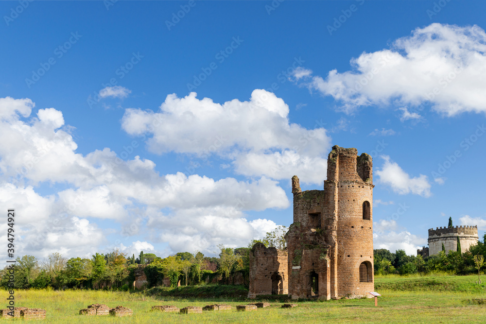 Beautiful picture of the Circo di Massenzio with tower and Cecilia Metella tomb in Appian way, with nature blue sky and clouds.