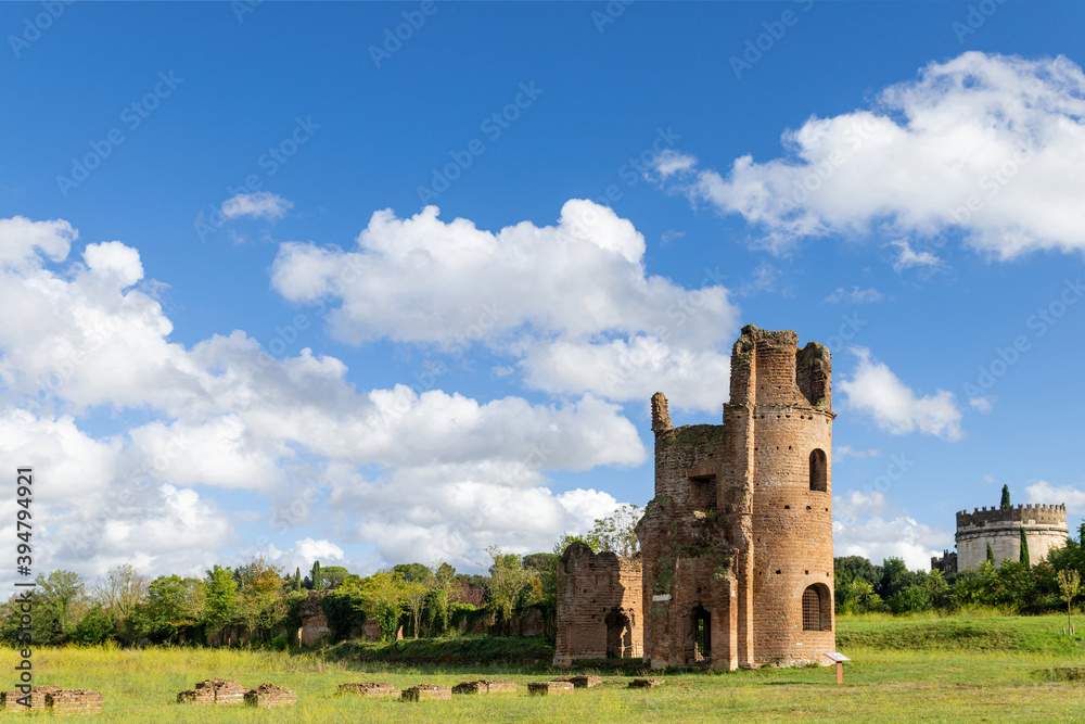 Beautiful picture of the Circo di Massenzio with tower and Cecilia Metella tomb in Appian way, with nature blue sky and clouds. Beautiful picture of the Circo di Massenzio with tower and Cecilia Metella tomb in Appian way, with nature blue sky and clouds.