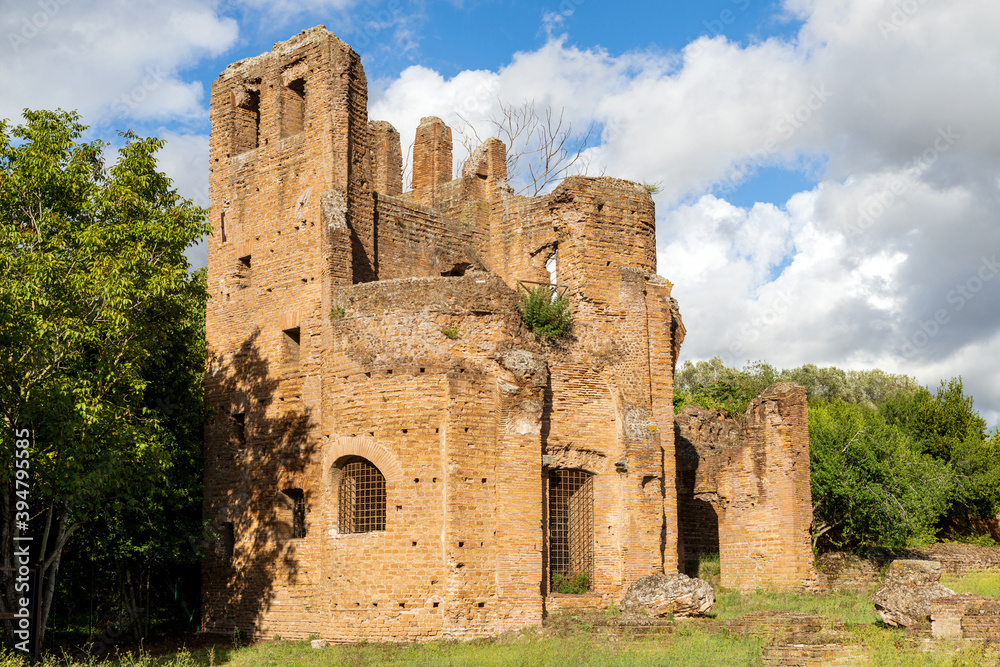Particular of Ancient ruins of circus of Maxentius along Via Appia or Appian Way Rome Italy, with a beautiful sun, clouds and nature.