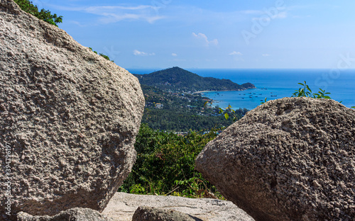 Island panoramic natural green view, small island and rocks foreground
