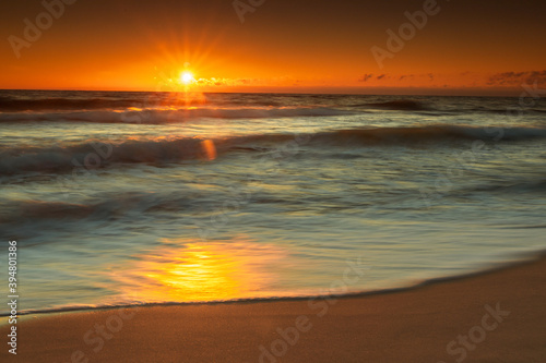 Fototapeta Naklejka Na Ścianę i Meble -  Baltic Sea in sunrise. Moving waves splashing in the coast