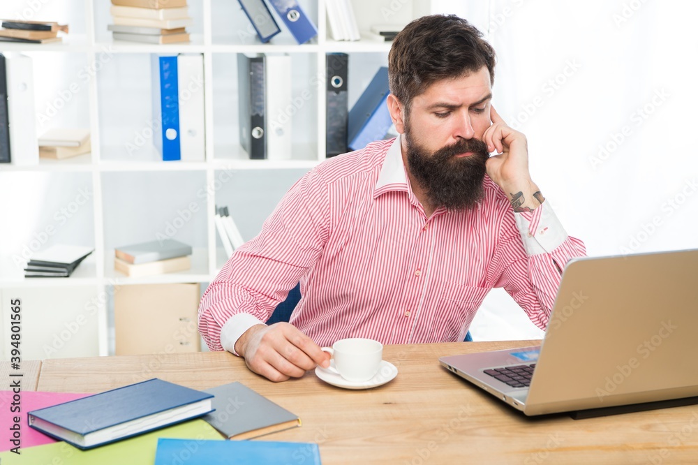 Serious hipster run business online using laptop computer technology in modern office, busy Serious hipster run business online using laptop computer technology in modern office, busy