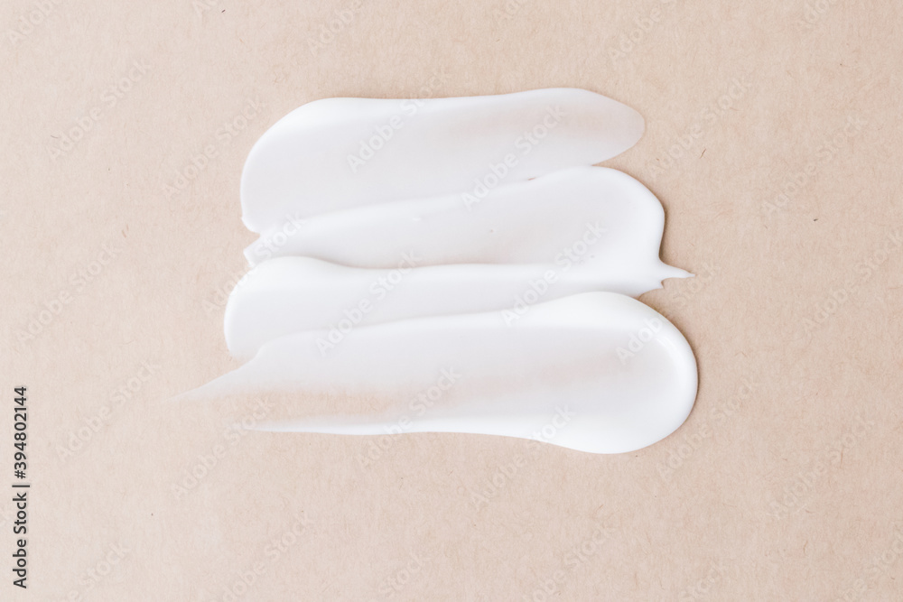 For care skin. A light cream smear on a beige background. Smear, mask, cream, light, face, beige background. For care skin. A light cream smear on a beige background. Smear, mask, cream, light, face, beige background.