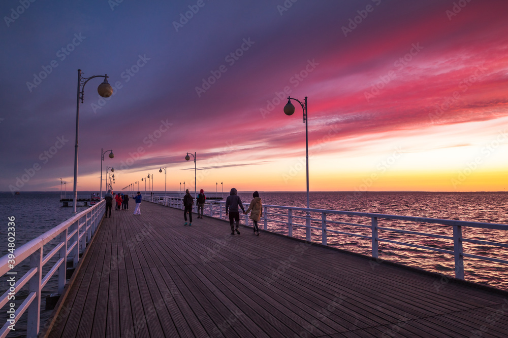 Pier in Jurata after sunset with a great red sky. 