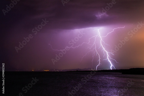 lightning striking the horizon during a thunderstorm at night in Formentera, Spain