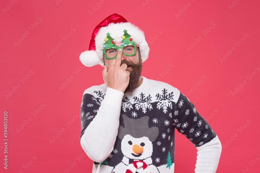 bearded man in sweater for celebration. show middle finger. prepare for xmas party. winter holiday fun. christmas tree decoration. shopping and sales concept. happy new year. merry christmas
