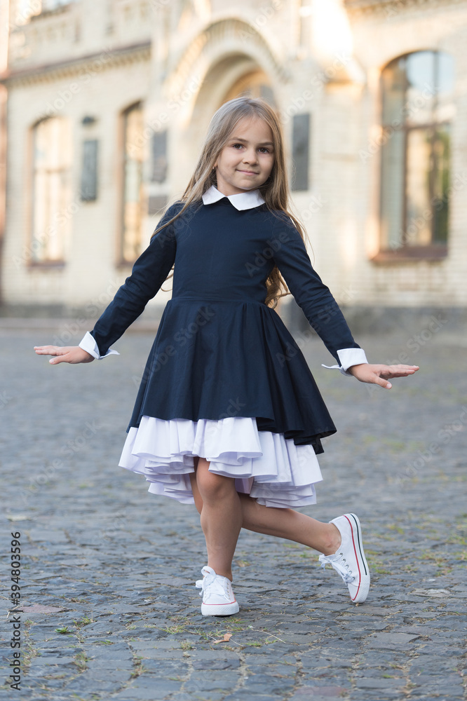 Going to dance lesson. Little kid make curtsy outdoors. Small dancer wear uniform. Ballet school. Dance education. Back to school fashion. Express yourself