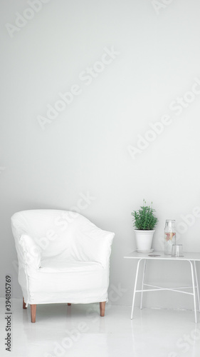white chair in white meditation space with a table and a plant © Quirván