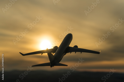 Silhouette of a plane taking off on the background of the sunset. Airline concept, travel tourism, flight. copy space