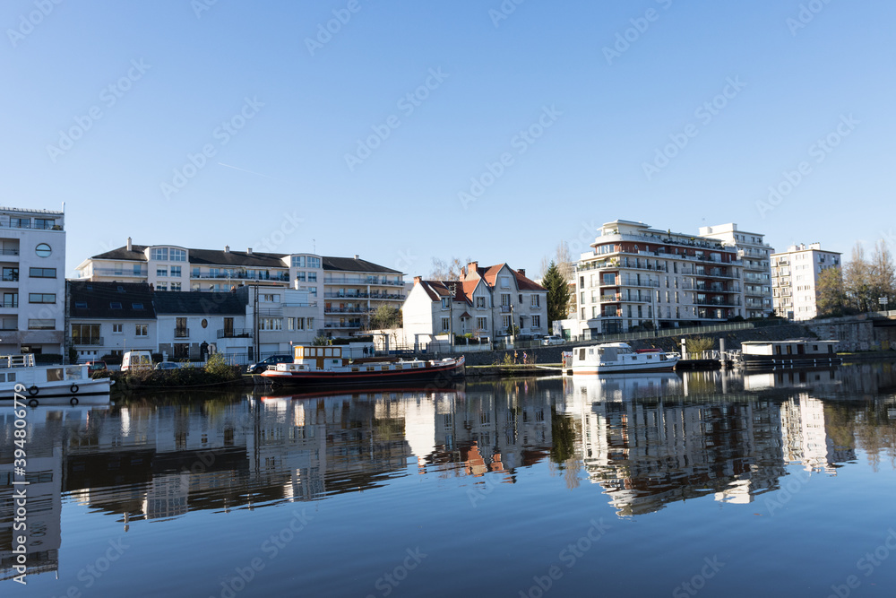 river with blue sky and buildings on the shore