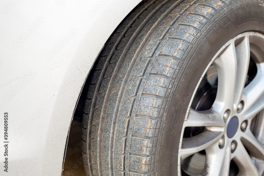 Close up of dirty car wheel with rubber covered rubber tire. Close up of dirty car wheel with rubber covered rubber tire.