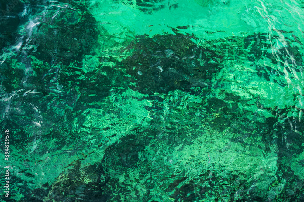 Clear turquoise rippled seawater full-screen texture, top view