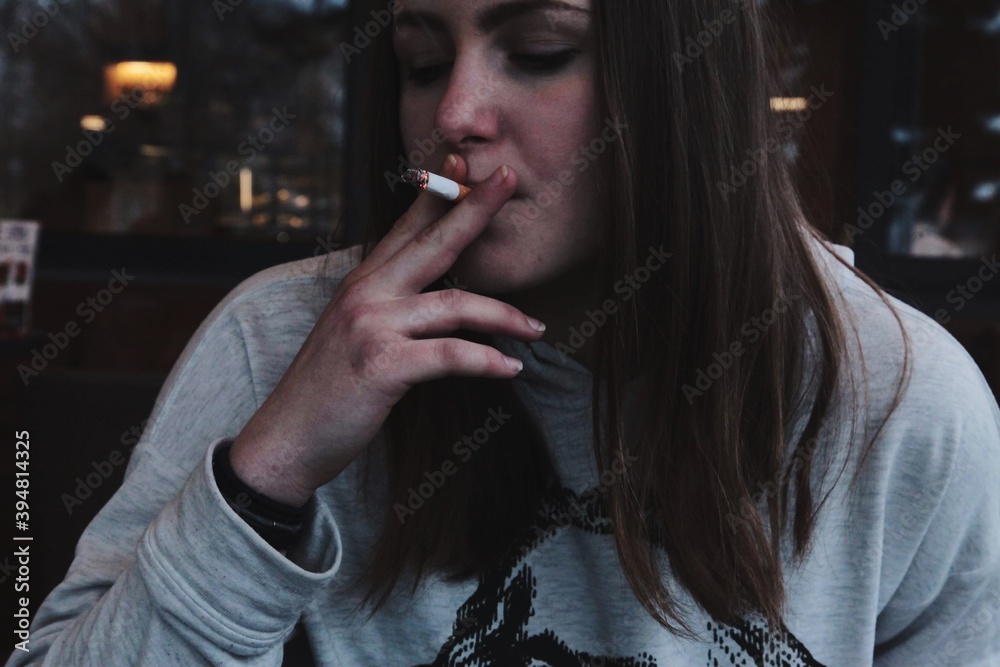 Young Woman Smoking Cigarette Stock Photo | Adobe Stock