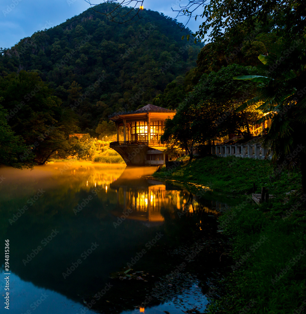 Fototapeta premium Beautiful night landscape with old pavilion on the water