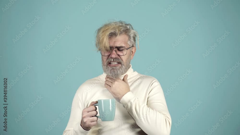 Ill man. Healthcare, people and medicine concept. Flu coughing and drinking hot tea from cup. Sick cold and headache. Cold season concept. Ill man. Healthcare, people and medicine concept. Flu coughing and drinking hot tea from cup. Sick cold and headache. Cold season concept.