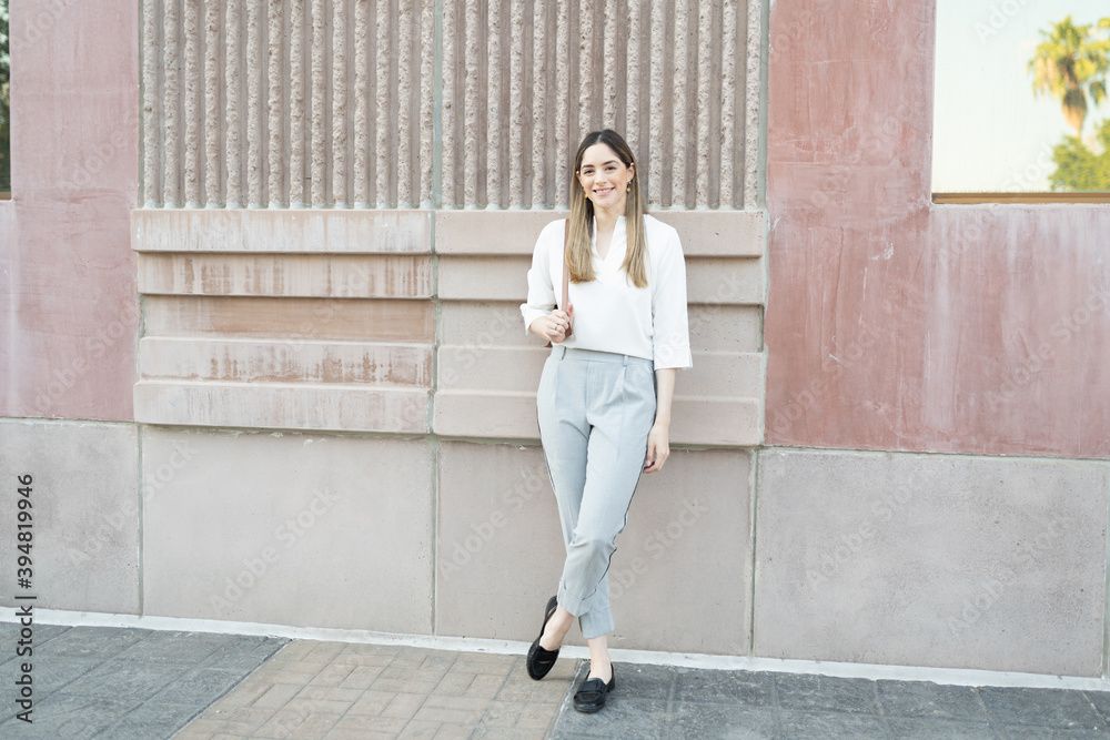 Businesswoman smiling and taking a break from her work Businesswoman smiling and taking a break from her work