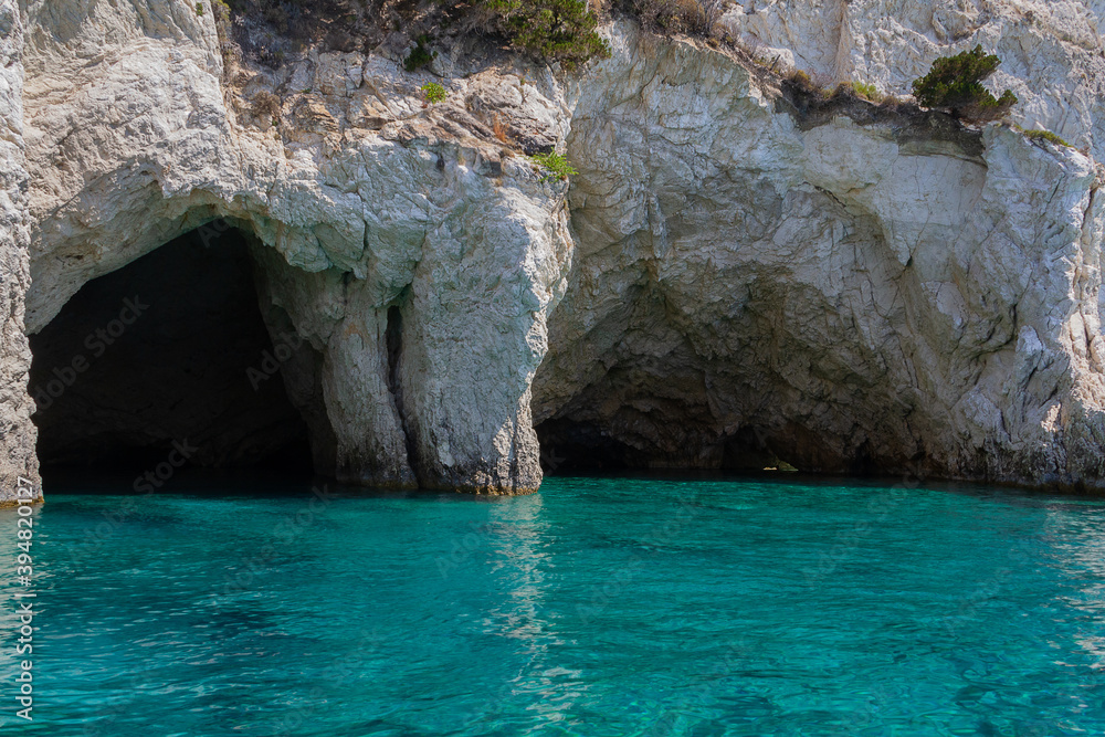 Seascape - picturesque caves in the coastal cliffs and blue water