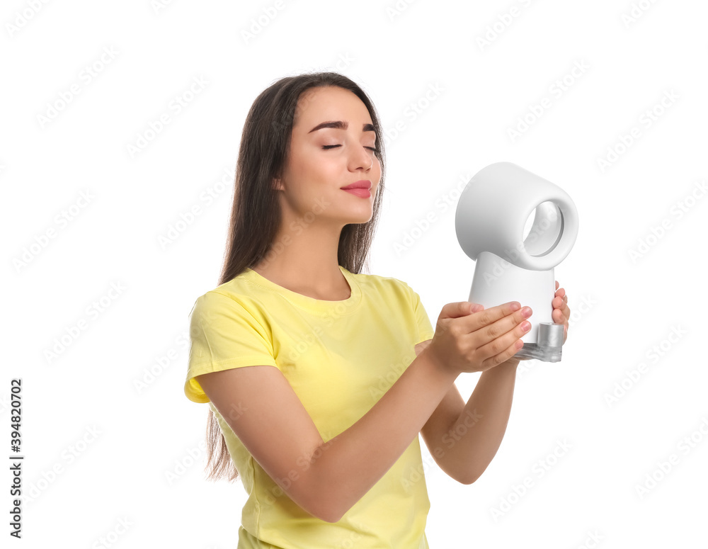 Woman enjoying air flow from portable fan on white background. Summer heat Woman enjoying air flow from portable fan on white background. Summer heat