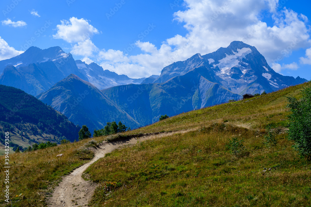 Hiking near ski station Les deux Alpes and view on Alpine mountains peaks in summer, Isere, France Hiking near ski station Les deux Alpes and view on Alpine mountains peaks in summer, Isere, France