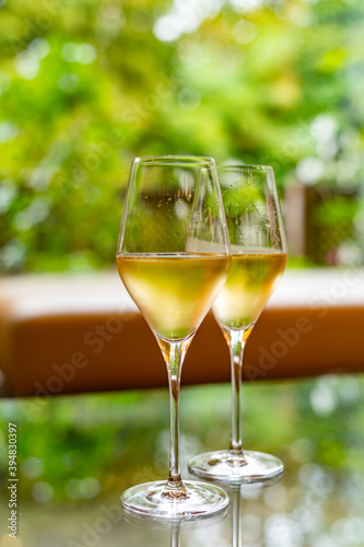 Tasting of french sparkling white wine with bubbles champagne on outdoor terrace in France