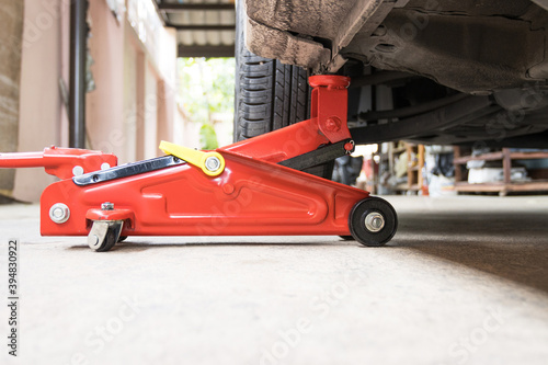 Car floor jack for car for repair check Maintenance of cars © piyaphunjun