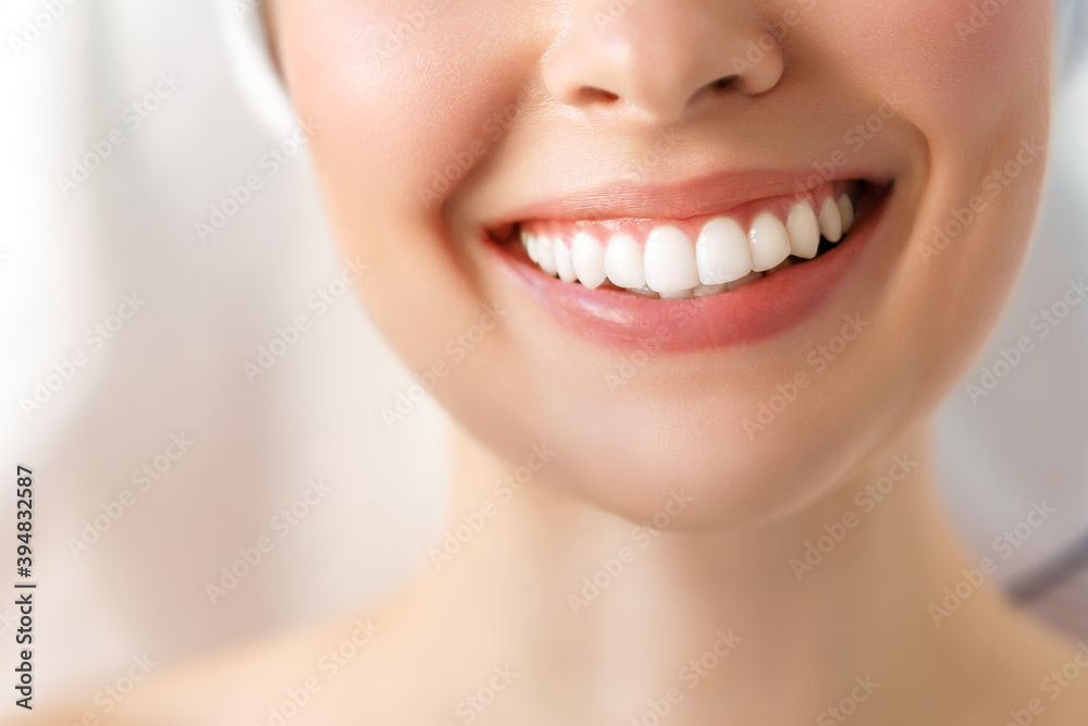 Obraz premium Perfect healthy teeth smile of a young woman. Teeth whitening. Image symbolizes oral care dentistry,