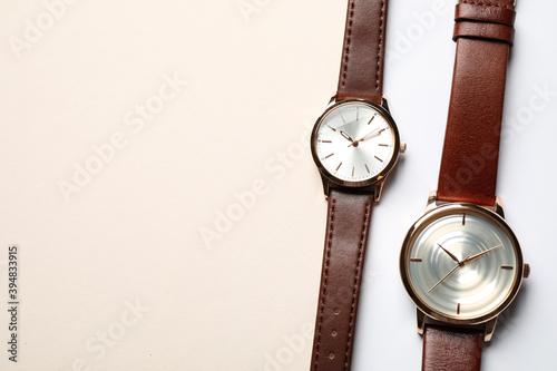 Luxury wrist watches on color background, flat lay. Space for text