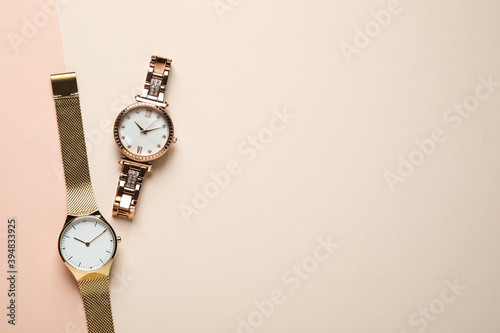 Luxury wrist watches on color background, flat lay. Space for text photo