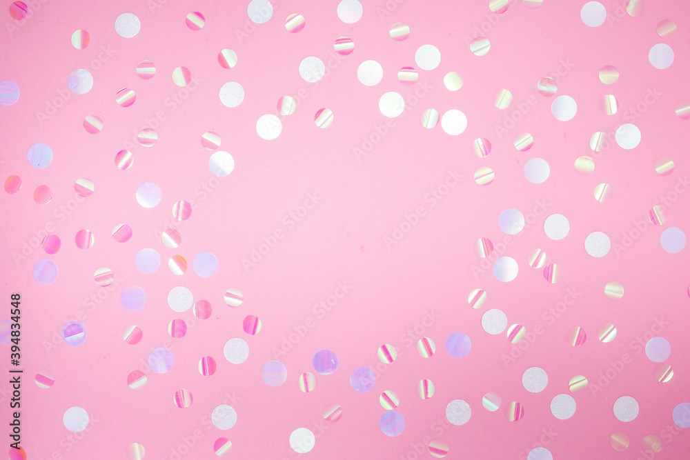 Delicate pink background with sparkles and confetti. Flat lay, top view, copy space, still life, background for greeting card