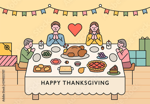 Families are sitting around a table on Thanksgiving and praying. flat design style minimal vector illustration.