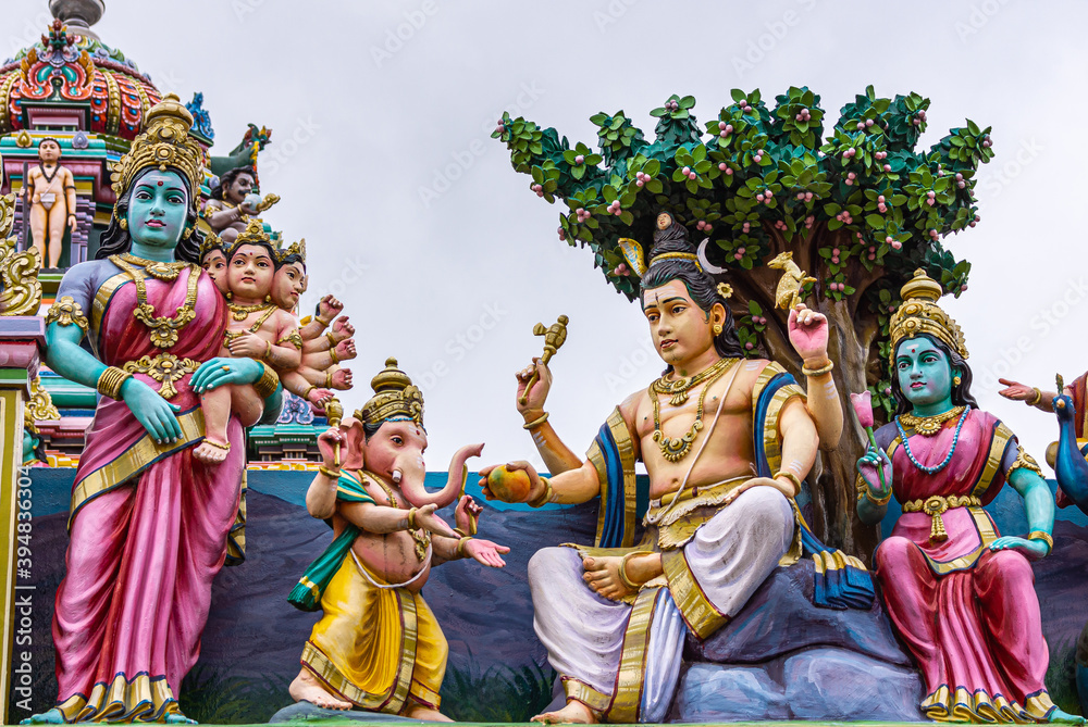 Kadirampura, Karnataka, India - November 4, 2013: Sri Murugan Temple. Colorful statues of Parvati holding 6-headed Murugan baby with Shiva, Ganesha, and Lakshmi on the side.