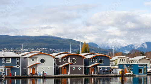 Cute, colourful floating houseboats line the docks in Mosquito Creek Marina, North Vancouver, British-Columbia. This alternative housing is growing in popularity with a challenging housing market.