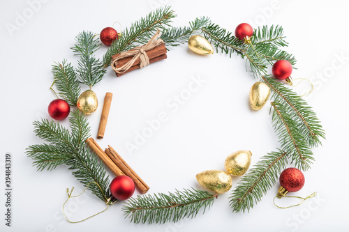 Christmas or New Year wreath composition. Decorations, balls, fir and spruce branches, on white background. Side view, copy space.