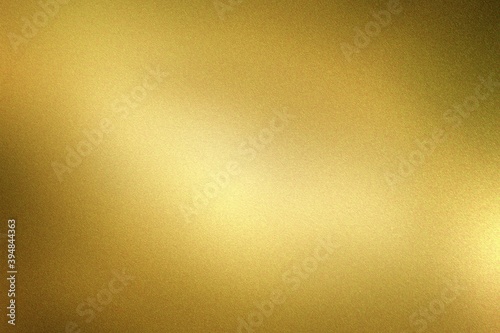 Glowing dark gold foil metal wall with copy space, abstract texture background