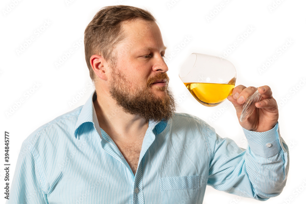 Solid bearded man in shirt tasting whisky studio portrait Solid bearded man in shirt tasting whisky studio portrait