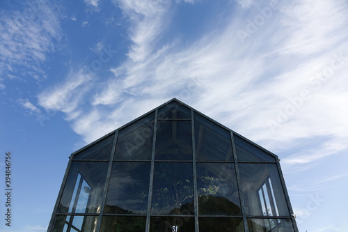 Glasshouse with sky and could background