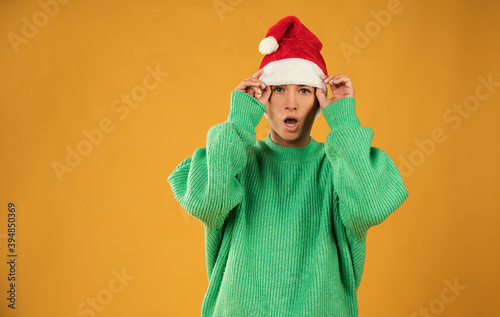 Surprised christmas girl wearing a santa hat  © Erika