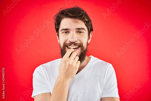 Bearded man fun emotions lifestyle cropped view white t-shirt red background