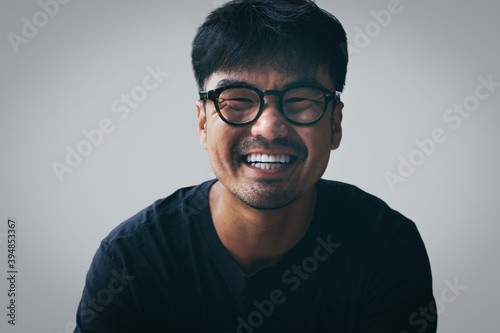asian man portrait young male wear eye glasses smiling cheerful look thinking position with perfect clean skin posing on white background.fashion people life style concept © panitan