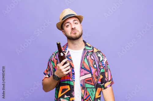 young man feeling sad and whiney with an unhappy look, crying with a negative and frustrated attitude photo