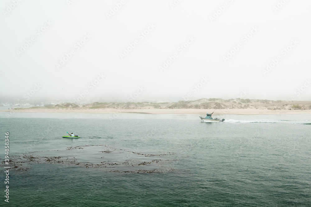 Ships, sailing boats and kayaks at Morro Bay harboar, California Coastline