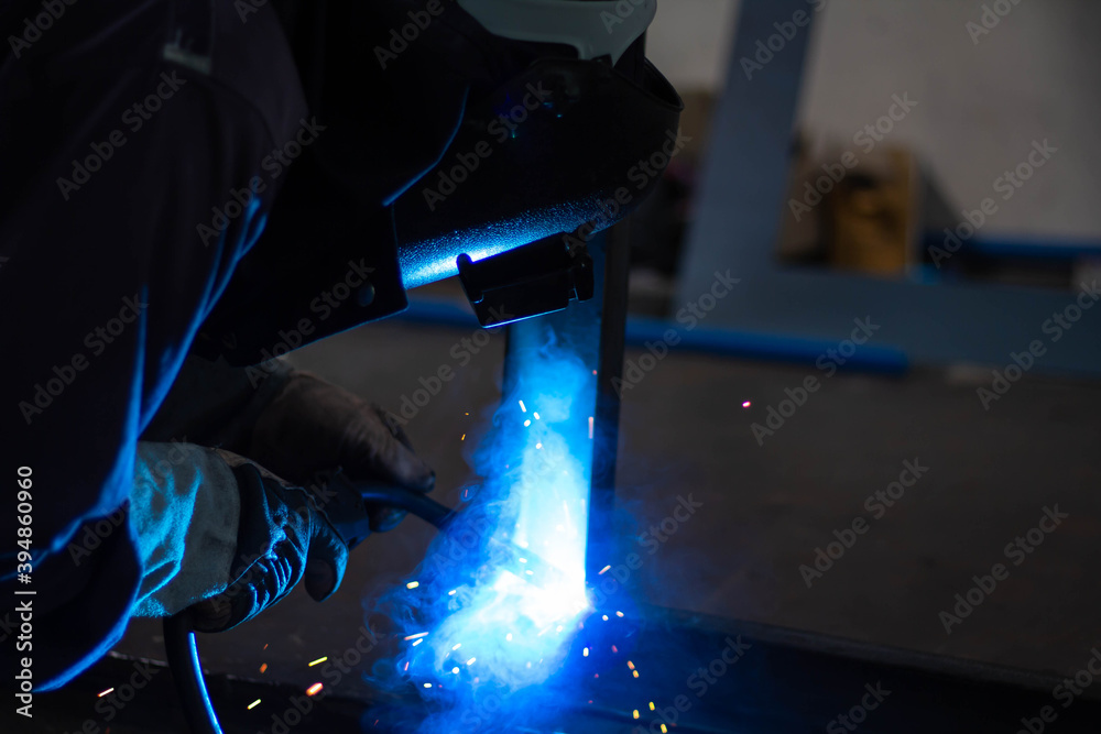 Metal workers use manual labor, Skilled welder, Factory workers making OT. Welder is welding the